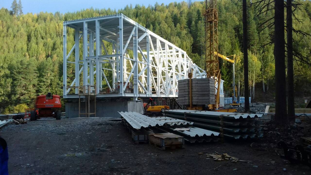 The Twist, early steel erection stage with roof cladding staged for installation